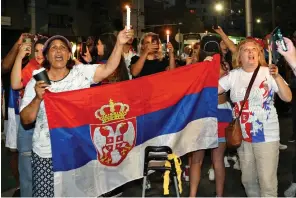  ?? ?? Passionate defence: Serbian fans at the detention centre last week