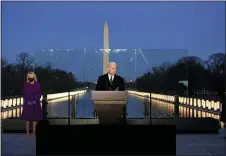  ?? PHOTOS BY ALEX BRANDON — THE ASSOCIATED PRESS ?? President-elect Joe Biden speaks during a COVID-19 memorial, with lights placed around the Lincoln Memorial Reflecting Pool, Tuesday, Jan. 19, 2021, in Washington.