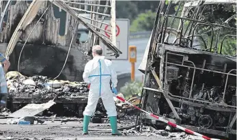  ?? Foto: 2x AP ?? Po tragédii Záchranář stojí před shořelým autobusem, z něhož zůstala jen holá kostra. Zraněné mezitím odvážejí vrtulníky.