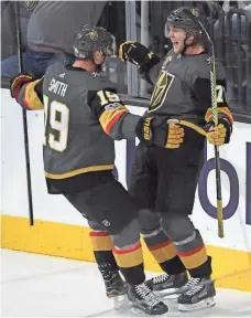  ?? STEPHEN R. SYLVANIE, USA TODAY SPORTS ?? Golden Knights center William Karlsson celebrates with right wing Reilly Smith after the two connected on Karlsson’s gamewinnin­g goal in OT against the Blues.