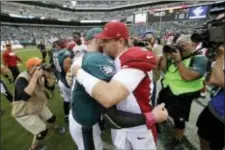  ?? MATT ROURKE — THE ASSOCIATED PRESS ?? A couple of mighty Carsons, Wentz, left, and Palmer, engage in mutual admiration after the Eagles’ 34-7 pounding of the Cardinals Sunday at Lincoln Financial Field.