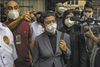  ?? Ezra Acayan / Getty Images ?? Maria Ressa, chief executive of online news site Rappler Inc., leaves court in Manila after being convicted of of libeling a wealthy businessma­n. She was sentenced to up to six years in prison.