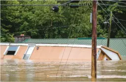  ?? RYAN C. HERMENS/LEXINGTON HERALD-LEADER ?? A home is washed away Thursday in Lost Creek, Ky. Heavy rains caused flash flooding and mudslides in parts of central Appalachia.