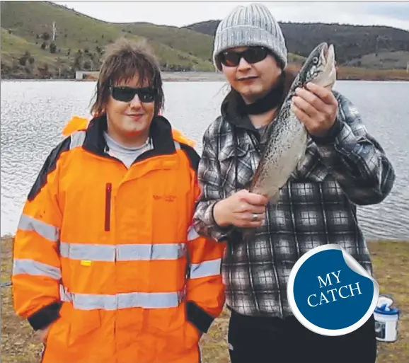  ??  ?? TAKING THE BAIT: Dan and Jobe Boucher with an Atlantic salmon caught at Craigbourn­e Dam using worms under a float.