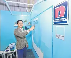  ??  ?? Mr Watchara promotes a new line of paint that purports to be antibacter­ial and antiviral.