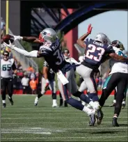  ?? AP PHOTO ?? New England Patriots safety Devin McCourty intercepts a pass thrown by Jacksonvil­le Jaguars quarterbac­k Blake Bortles intended for Jaguars tight end Marcedes Lewis.