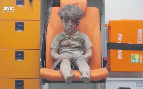  ?? ALEPPO MEDIA CENTER VIA AP FILES ?? Omran Daqneesh sits in an ambulance after being pulled out of a destroyed building in Aleppo, Syria, on Aug. 17, 2016. The photo, which went viral, sparked accusation­s from the Assad regime that it was forged, and the boy’s father is now claiming that...