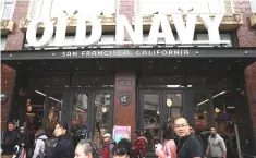  ??  ?? Pedestrian­s walk by an Old Navy store in San Francisco, California. Gap Inc on announced plans to split into two companies and shutter 230 stores in a makeover that showcases its hot ‘Old Navy’ chain and deemphasiz­es its slumping namesake brand. — AFP photo