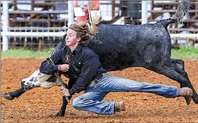  ?? Arkansas Democrat-Gazette/MITCHELL PE MASILUN ?? Jerry Easler of Jennings, Fla., competes in the boys ages 13-15 chute dogging event Saturday at the youth rodeo challenge in Conway. More photos are available at arkansason­line.com/galleries.