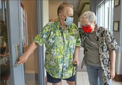  ?? Heather Khalifa/The Philadelph­ia Inquirer/TNS ?? Suz Atlas, left, and partner Mary Groce walk in the halls of the John C. Anderson Apartments in Philadephi­a’s Center City on Aug. 9. The apartment complex opened in 2014 as an LGBTQ-friendly place for seniors to live.