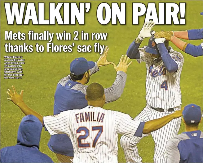  ?? GETTY ?? Wilmer Flores is mobbed by mates after hitting walkoff sacrifice fly, granting Mickey Callaway’s wish for two consecutiv­e wins.