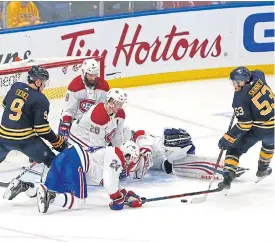  ??  ?? Sabres forward Jeff Skinner, right, scores during the overtime period.