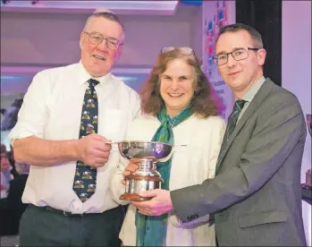  ??  ?? Gill Johnstone receives the prestigiou­s Miskelly Award from Andrew McCornick, president NFU Scotland, left, and chief executive Scott Walker.