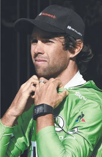  ?? Picture: AFP ?? NO SURRENDER: Australia's Michael Matthews puts on his green jersey for best sprinter on the podium at the end of the 183km 17th stage of the Tour de France