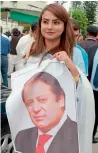  ?? AFP ?? PML-N lawmaker Maiza Hameed holds a poster of Nawaz Sharif outside Parliament House. —