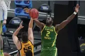  ?? DARRON CUMMINGS — THE ASSOCIATED PRESS ?? Iowa’s Luka Garza (55) has his shot blocked by Oregon’s Eugene Omoruyi (2) during the first half of a secondroun­d game in the NCAA Tournament at Bankers Life Fieldhouse on Monday in Indianapol­is.