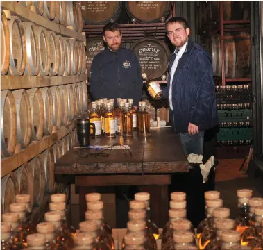  ?? Photo by Declan Malone ?? Hands on: Dingle Distillery Director Elliot Hughes (right) and Cormac O’Connor labelling the first bottles of whiskey produced at the distillery in advance of the local launch on Thursday. The whiskey was also bottled and corked by hand in Milltown.