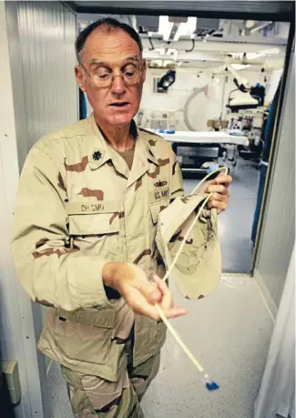  ?? Photo: REUTERS ?? Controvers­ial measures: A senior medical officer who asked to not be identified holds a feeding tube as he explains the treatment of detainees who go on hunger strikes at Camp Delta at the Guantanamo Bay Naval Station in Cuba.