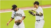  ?? K.C. ALFRED U-T ?? Padres third baseman Manny Machado congratula­tes reliever Luis Patino in the fifth inning.