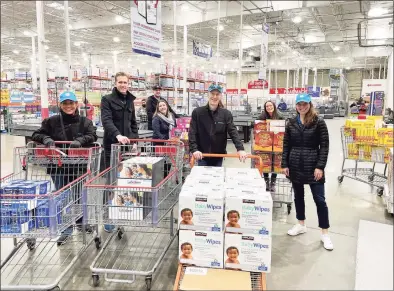  ?? Contribute­d photo ?? Priceline CEO Brett Keller, second from left, with colleagues at Costco in Norwalk on Nov. 21 as part of Priceline's Thanksgivi­ng charitable drive that raised nearly $100,000 supporting the Food Bank of Lower Fairfield County.