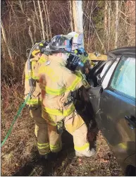  ?? ?? Brookfield firefighte­rs use the Jaws of Life to extricate a driver from a car after a crash on Route 7 on Wednesday.