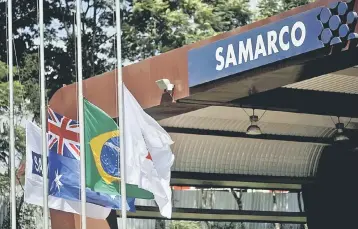  ??  ?? An Australian (second left) and a Brazilian (second right) flags are pictured on the entrance of the mine operator Samarco owned by Vale SA and BHP Billiton Ltd in Mariana, Brazil. — Reuters photo