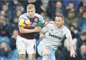  ??  ?? Burnley’s Ben Mee in action with West Ham’s Marko Arnautovic. — Reuters photo