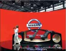  ?? LI FUSHENG / CHINA DAILY ?? A Nissan staff member introduces the carmaker’s future vehicle technology at the 2019 CES Asia held in Shanghai.