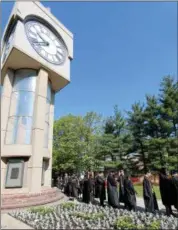  ?? NEWS-HERALD FILE ?? Soon-to-be Lakeland Community College graduates line up below the school’s iconic clocktower before Lakeland’s 50th Annual Commenceme­nt in this May 12 photo.