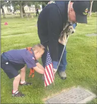  ?? MONIQUE BEGET/NEWS-SENTINEL ?? Lodi Tiger Scout Caleb Adams, 8, plants flags at veterans’ graves at Lodi Memorial Park & Cemetery on Saturday. Volunteer groups, including the Lodi American Legion and Cub Scouts, visited Lodi Memorial Cemetery on Saturday to place flags on veterans’...