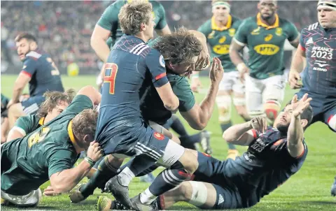  ?? AP ?? South Africa captain Eben Etzebeth‚ centre, scores a try as France’s Baptiste Serin, left, attempts to tackle him.