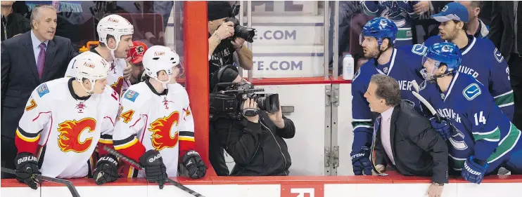  ?? GERRY KAHRMANN/PNG FILES ?? In 2014, Calgary head coach Bob Hartley and Vancouver head coach John Tortorella got into a heated exchange over starting lineups.