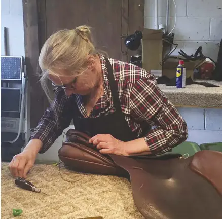  ??  ?? repairing a saddle at the north american saddlery school.