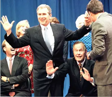  ??  ?? File photo shows Bush (centre) tries to make room for his portrait as his sons then Texas governor George Bush (left) and then Florida Governor Jeb Bush (right) horse around during a family portrait session, in Houston. — Reuters photo