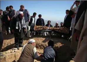  ?? (AP/Mariam Zuhaib) ?? Afghans gather Sunday at a cemetery west of Kabul to bury a victim of the school bombing.