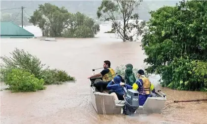  ?? ?? Aidan Ricketts from North Lismore steers his boat. He lost his house but rescued 16 people and their dogs from the floods. Photograph: Eddie Loyd