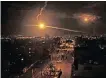  ?? AFP SAID KHATIB ?? A FLARE fired by Israeli forces lights the sky above the town of Rafah, in the southern Gaza Strip, early on Sunday. |