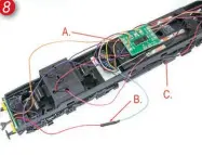  ?? ?? 8: The installati­on required for independen­t control of the red tail-lights:
A: Red light board leads are disconnect­ed from the main circuit board.
B: One light board red lead is connected to the decoder green wire (function F1)
C: The other light board red wire is connected to the decoder purple wire (function F2).