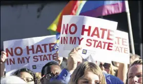  ?? AP ?? Protesters call for Mississipp­i Gov. Phil Bryant to veto House Bill 1523, which they say will allow discrimina­tion against LGBT people, during a rally April 4. Some say LGBT protection­s, longer maternity leave and a higher minimum wage can pay off in...