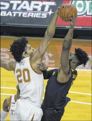  ?? Michael Thomas The Associated Press ?? Texas forward Jericho Sims blocks a shot by West Virginia forward Derek Culver in the first half of the Mountainee­rs’ 84-82 win Saturday.