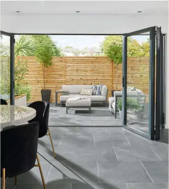  ?? ?? ABOVE Create a seamless look indoors and out
Everscape Enis Black tiles, £55.49sq m, Topps Tiles