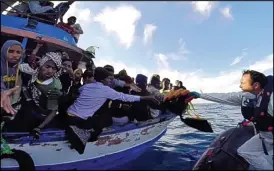  ??  ?? Perilous journey: Italian coastguard­s rescue another boat off Sicily