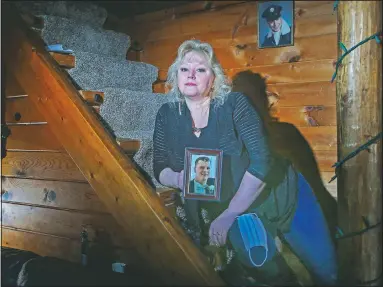  ?? (AP/Stew Milne) ?? Cynthia Archambaul­t poses with photos of her late brother Daniel Remillard, in hand, and father Ronald Remillard in Woonsocket, R.I.