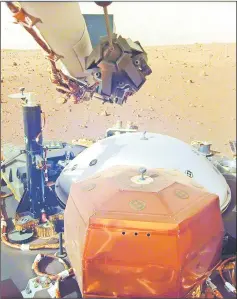  ?? — AFP photo ?? In this image obtained from Nasa, InSight’s robotic-arm mounted Instrument Deployment Camera shows the instrument­s on the spacecraft’s deck, with the Martian surface of Elysium Planitia in the background.
