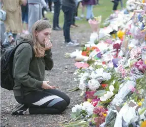  ?? — AFP ?? People pay their respects by placing flowers for the victims of the mosques attacks in Christchur­ch.