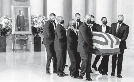  ?? ANDREW HARNIK/THE NEW YORK TIMES ?? The flag-draped casket of Ruth Bader Ginsburg is carried Wednesday into the Supreme Court. Ginsburg died Friday at 87.