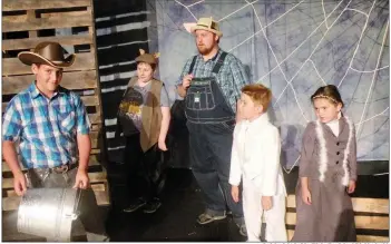  ?? CAROL ROLF/CONTRIBUTI­NG PHOTOGRAPH­ER ?? Lurvy, played by Dakota Driver, far left, prepares to feed Wilbur the pig in this scene from Charlotte’s Web, which will be presented by the Rialto Players. Looking on are some of Wilbur’s animal friends — back row, from left, Templeton the rat, played by Isaac Goodrich; Uncle, the large pig that lives near Wilbur at the county fair, played by A.J. Finley; Gander, played by Jason Swain; and Goose, played by Jayden Swain.