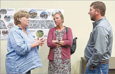  ?? Westside Eagle Observer/RANDY MOLL ?? Gentry Chamber of Commerce director Jamie Parks (Left) visits with Gwyn and Rustin Unruh, owners of Flint Creek Amish Furniture on Gentry's Main Street, following the Oct. 26 presentati­on on plans to revitalize Main Street.