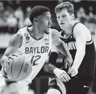  ?? Sarah Stier / Getty Images ?? Baylor junior guard Jared Butler, left, the Big 12 player of the year, is adept at playing both ends of the floor. He led the league in steals (2.0) and was third in scoring with 16.5 points per game.