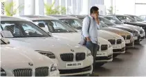  ??  ?? A MAN takes a look at secondhand BMW cars at a dealer shop in Beijing, China, Sept. 11, 2015.